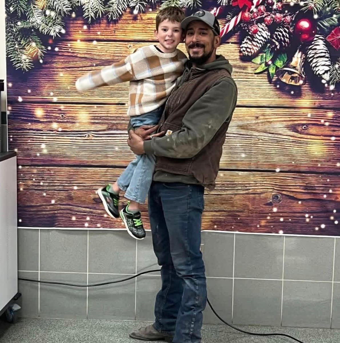 Ryan Flynn, founder of In Like Flynn LLC, holding his son